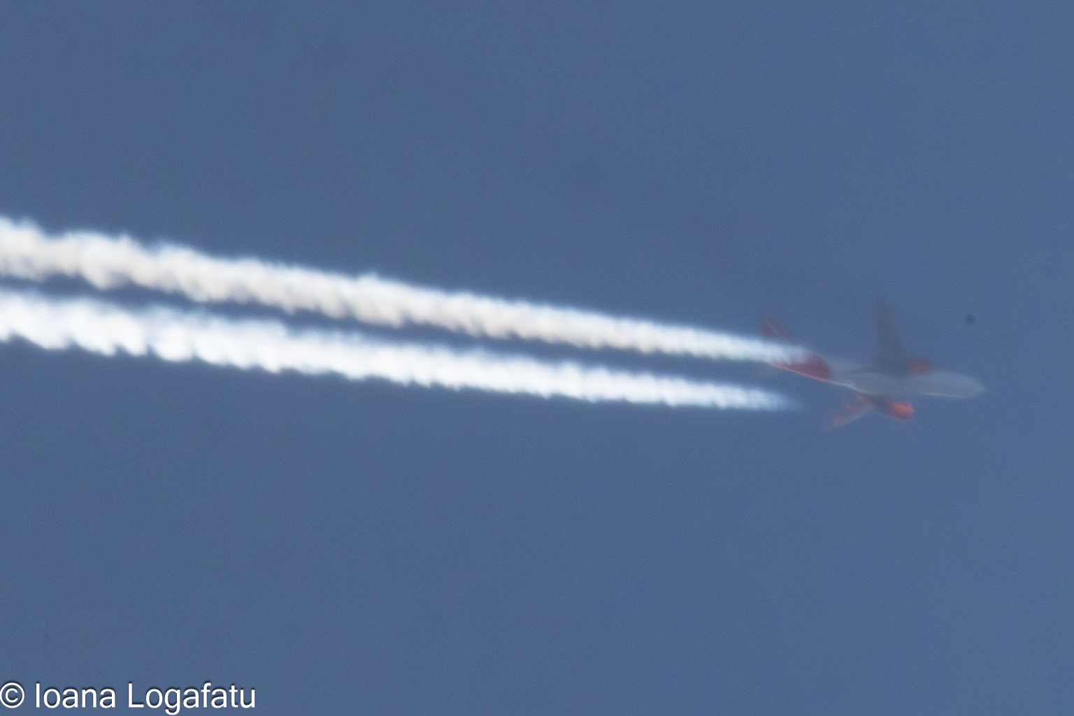 Plane soaring in twilight clouds